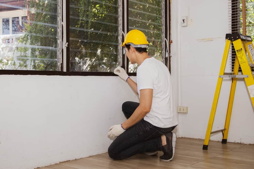 Male Staff, Asian Termite Exterminators Wearing Hard Hats Inspecting Old